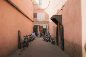 Wood workers finishing a door down a back alley of Marrakesh busy Souk markets.