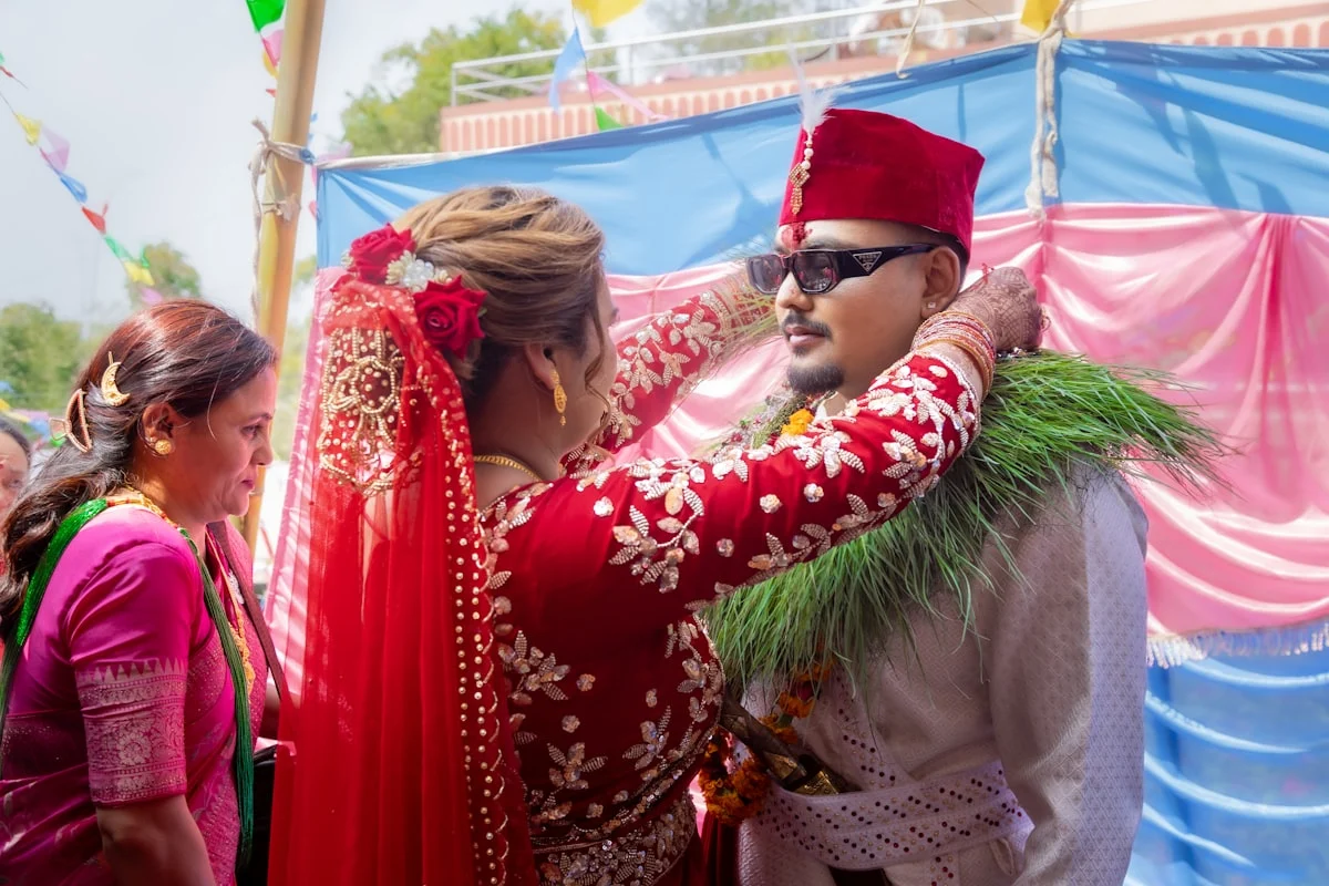 Bride and Groom Exchanging Malas and Rings | Nepali Swayambar Ceremony. During a Nepali Swayambar ceremony, the bride and groom exchange malas around each other’s necks and rings, symbolizing their love and commitment. Surrounded by family and blessings at the mandap, this sacred ritual honors mutual consent, celebrates rich cultural traditions, and marks the joyful beginning of their journey toward marriage.