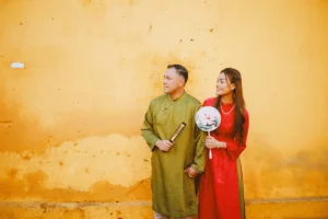 Capturing Timeless Love: An Ao Dai Couple Photoshoot in Hoi An's Serene Morning Begin your day with an enchanting Ao Dai couple photoshoot in Hoi An's early morning. This serene time offers soft, golden light and quiet streets, providing the perfect intimate backdrop for your love story. Wearing the elegant Vietnamese traditional dress, you'll create timeless memories that truly reflect the cultural beauty of Hoi An.