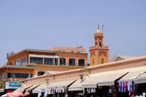 Market stalls with a minaret in the background.