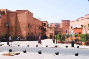 People walking in a sunlit moroccan town square.