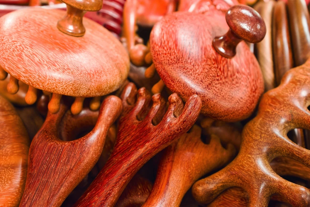 Collection of wooden massage tools on display in a local workshop for handmade crafts - Various wooden massage tools are arranged together in a local workshop. They show different shapes and designs. The warm tones of the wood create a unique collection.