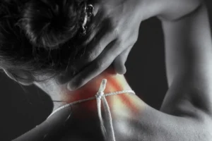 Acute pain in the back of a woman. Pain in the back and neck.