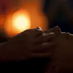 persons hand on top of sun